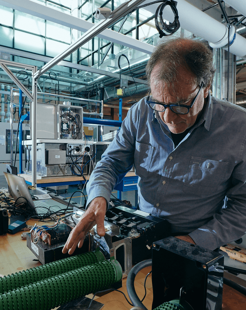 Team collaborating in a brainstorming session, discussing ideas with sticky notes and prototypes on the table.